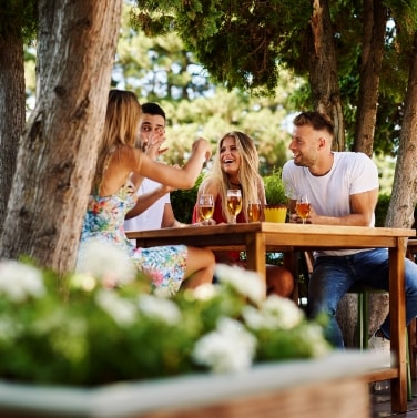 two smiling couples sitting at outside table at Citadel Mall